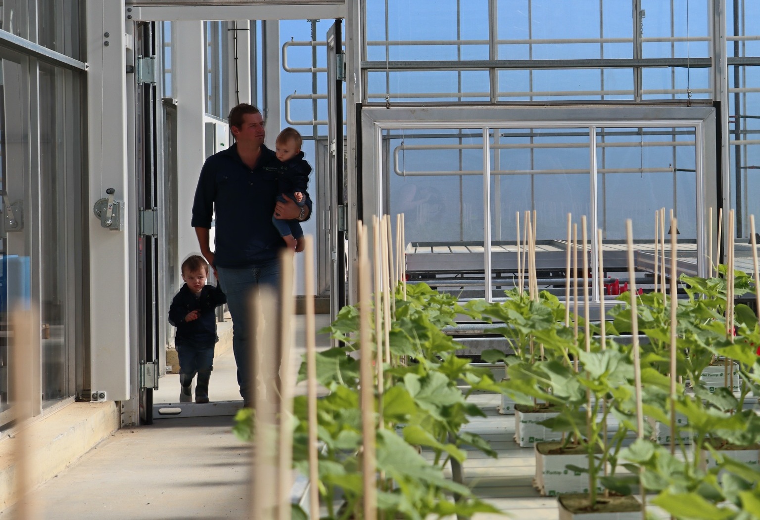 Jack walking through the nursery with his children